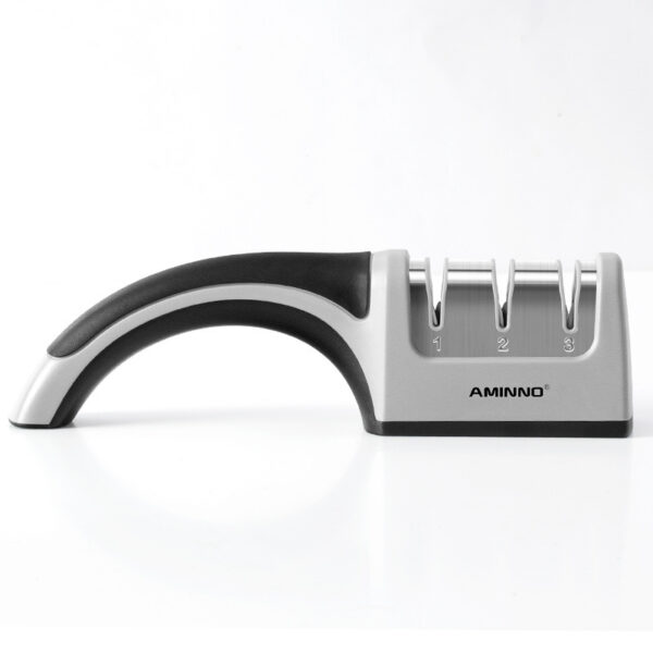 A Four-in-one Family Uses A Sharpener To Sharpen A Kitchen Knife - Image 2